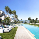 Pool area at Nubay Manilva surrounded by palm trees and greenery