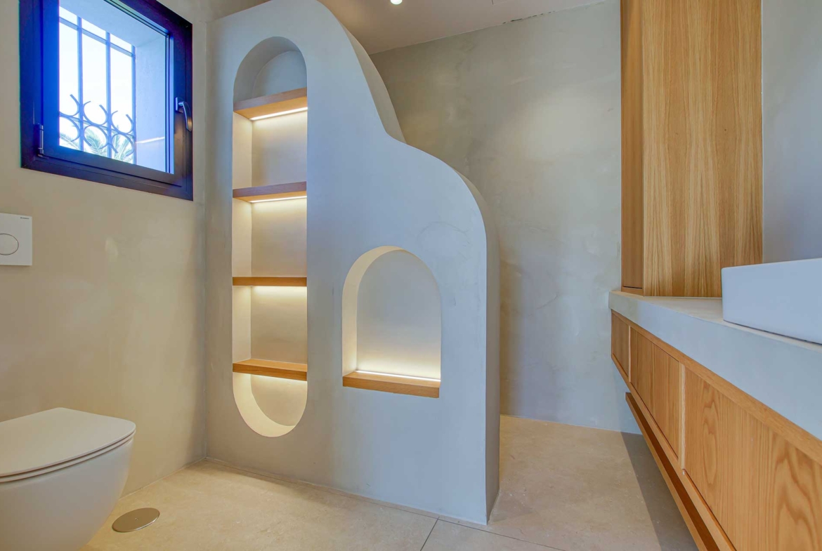 Modern bathroom with custom shelving and soft lighting in a penthouse for sale in Centro Plaza.