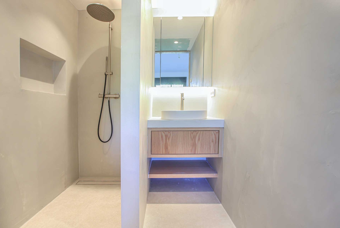 Modern shower with rainfall showerhead in Centro Plaza penthouse.