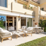 Outdoor terrace at Casa Chloe, featuring modern furniture, lush greenery, and seamless indoor-outdoor living in La Quinta Hills