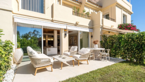 Outdoor terrace at Casa Chloe, featuring modern furniture, lush greenery, and seamless indoor-outdoor living in La Quinta Hills