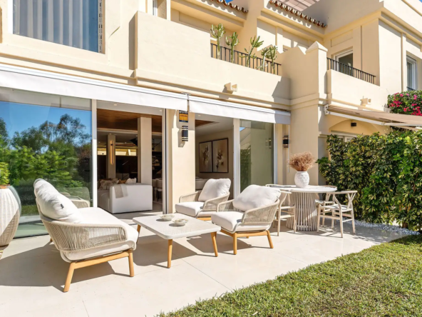 Outdoor terrace at Casa Chloe, featuring modern furniture, lush greenery, and seamless indoor-outdoor living in La Quinta Hills