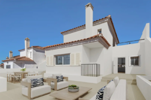 Modern exterior of an Olimpo Mijas villa with outdoor seating and a sunny terrace.