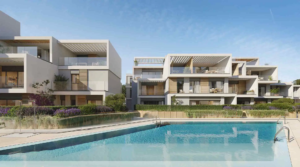 Daytime pool view at Isla Bela Marbella with surrounding modern residences.