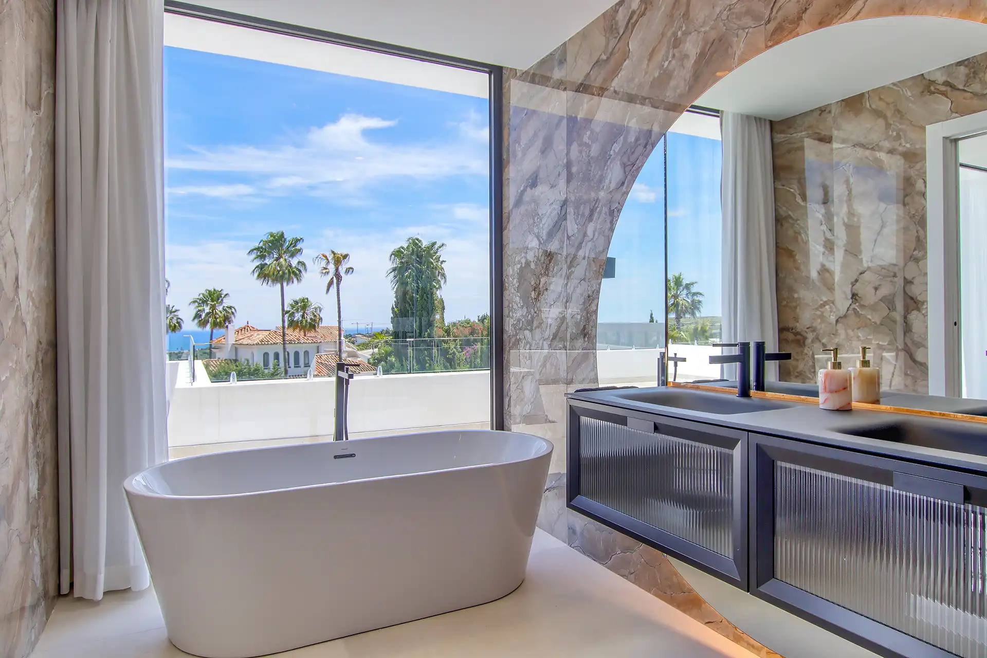 Luxury bathroom with freestanding bathtub and panoramic sea views in Valle Romano villa.
