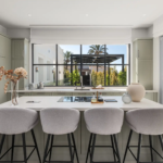 Modern kitchen with central island and large window at Villa Valora, Marbella