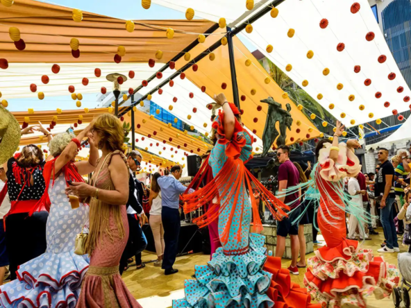 People dancing and celebrating under festive decorations at Marbella San Bernabe