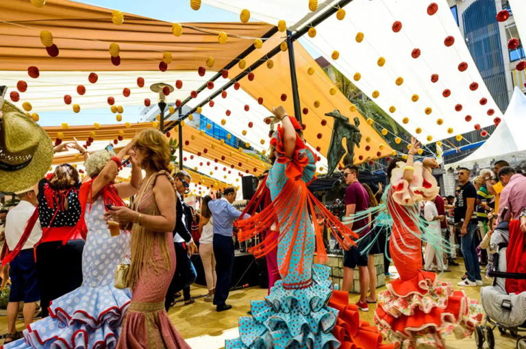 People dancing and celebrating under festive decorations at Marbella San Bernabe