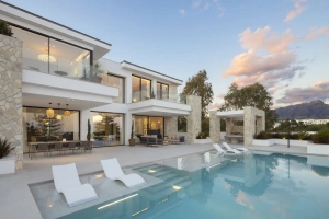 Contemporary villa featuring a swimming pool and outdoor seating area in a residential setting.