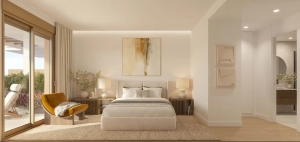 Master bedroom in Kosmos Fuengirola apartment with cozy chair and neutral decor