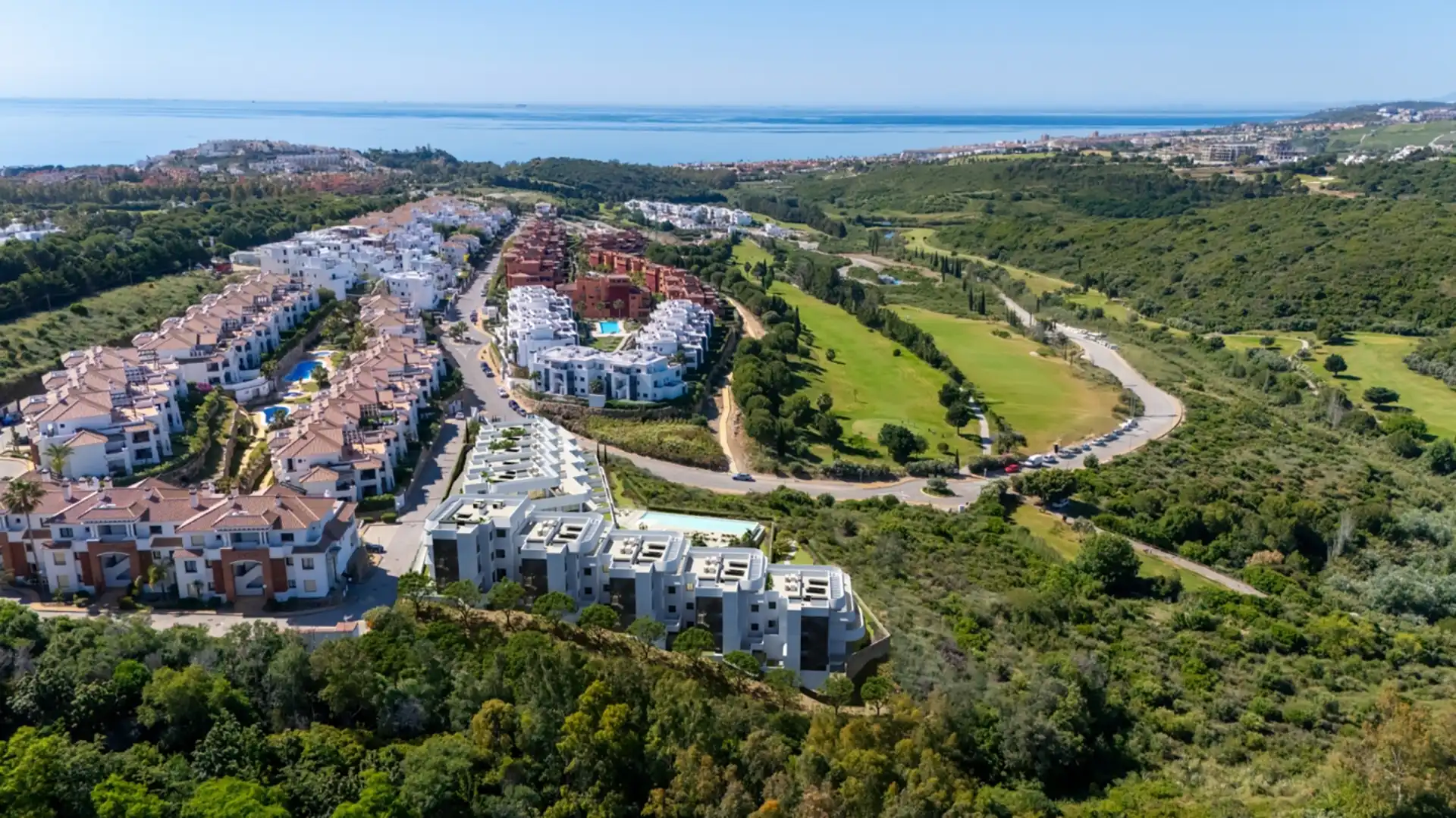 Aerial view of Skye Casares Golf development surrounded by greenery and golf courses on the Costa del Sol