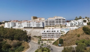 Aerial view of a modern residential complex in Fuengirola with multiple buildings and surrounding greenery.
