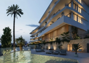 A modern apartment building featuring a pool and palm trees in the foreground.