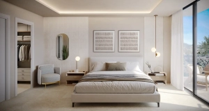 A modern bedroom featuring a bed, nightstands, and decorative art on the walls in Belvedere Colecttion