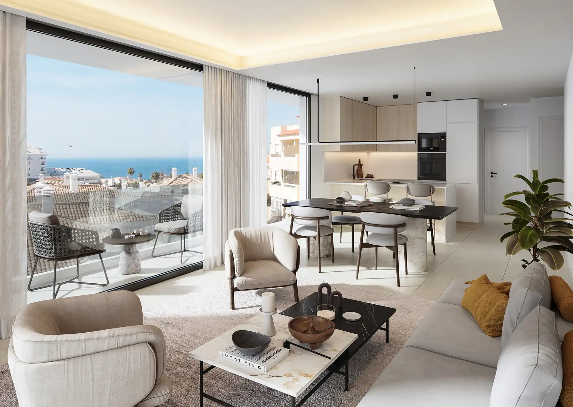 Interior view of a modern living room and kitchen with large windows showing a sea view.