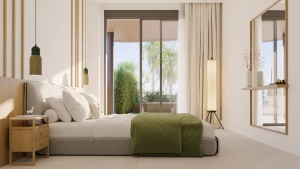 A modern bedroom featuring a bed with white linens and a green throw blanket, along with wooden accents.