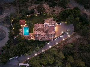 Aerial view of Villa Las Palmeras in Benahavis featuring a pool and landscaped surroundings.