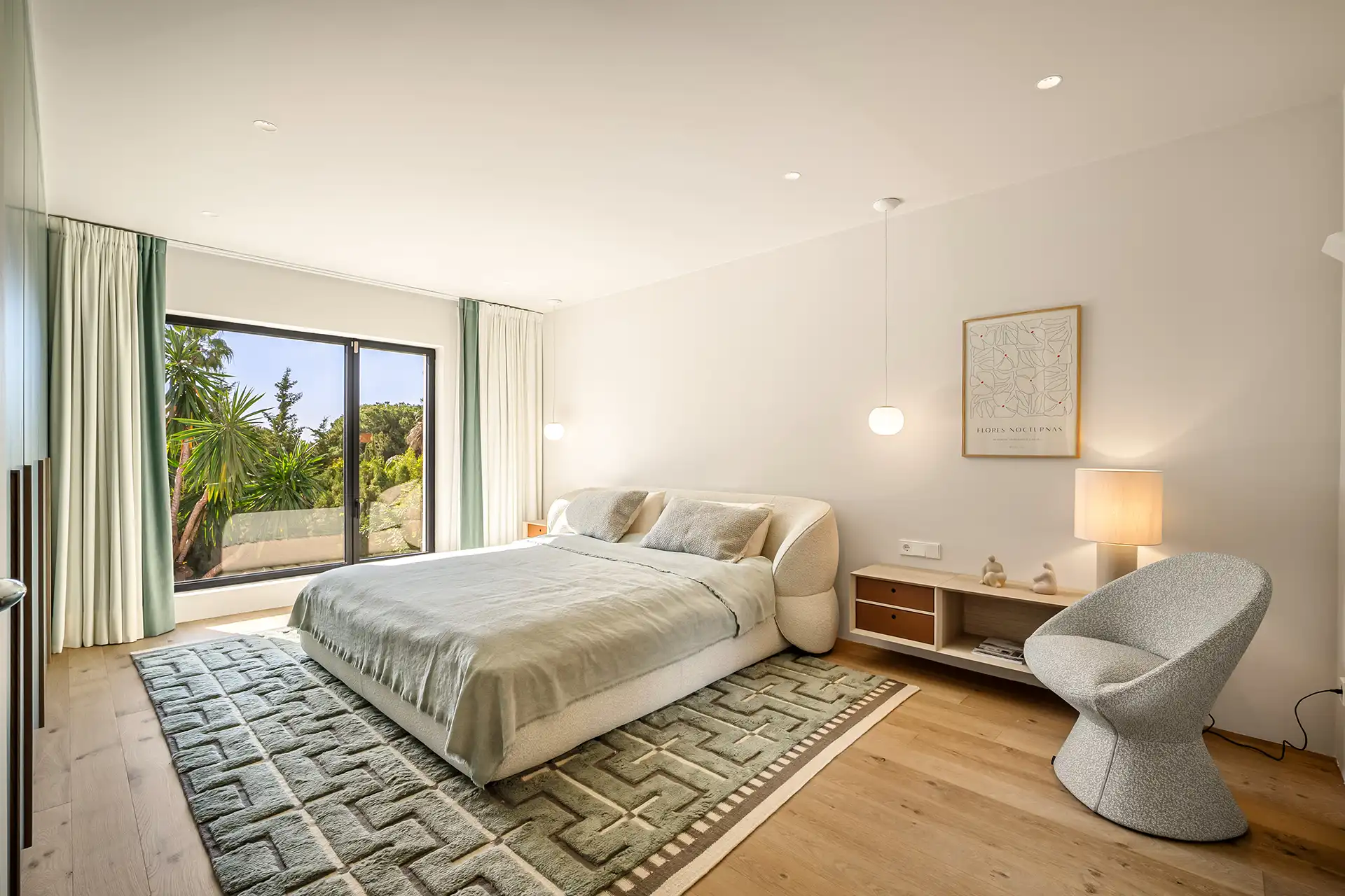 Villa Madrisa contemporary bedroom featuring a large window, a bed with a soft blanket, and minimalist furniture.