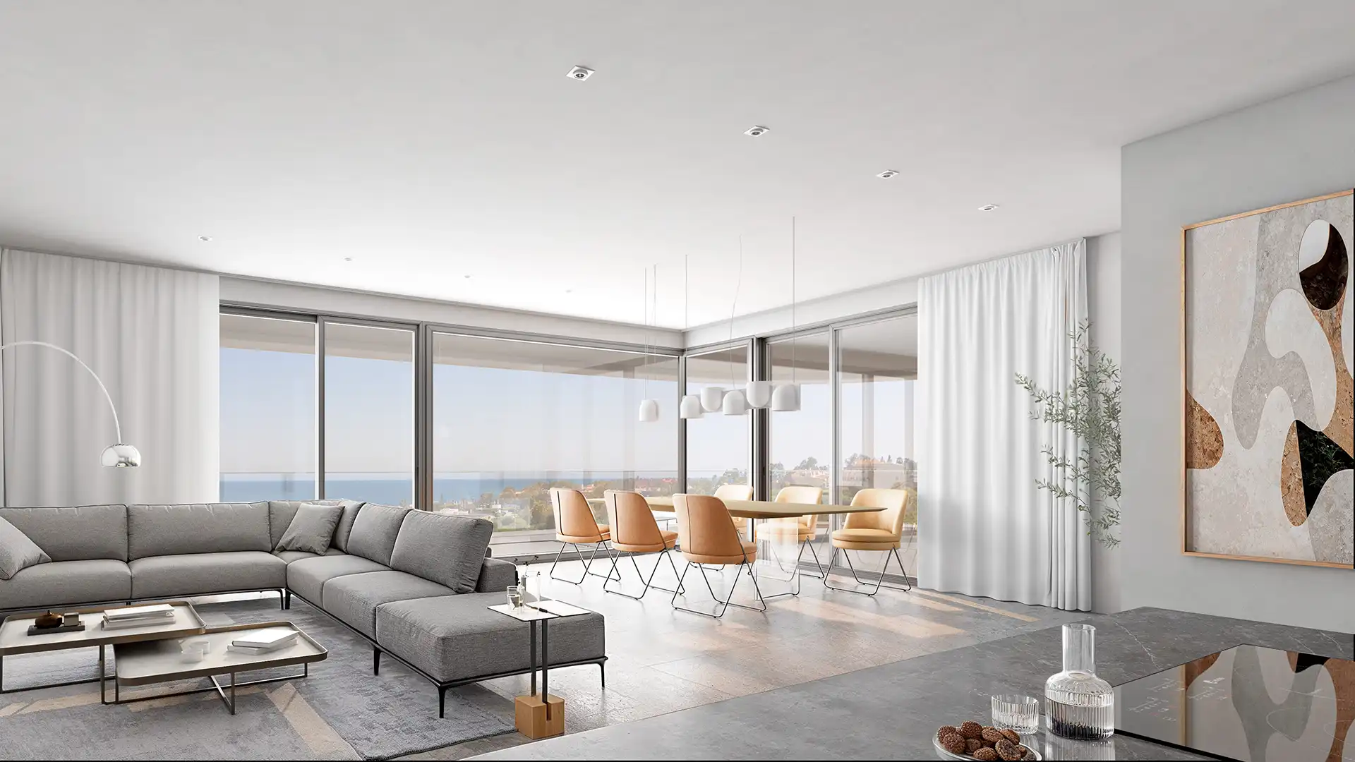 Contemporary living room featuring a sectional sofa, dining table, and large windows with ocean view.