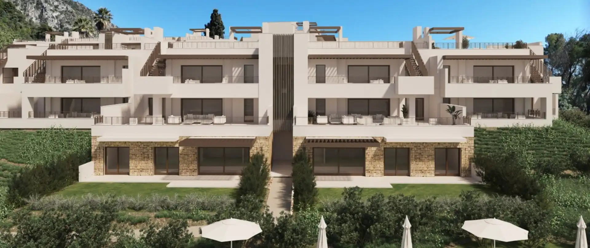 Modern terraced apartment complex with stone accents and rooftop terraces at Almazara Gardens Istán