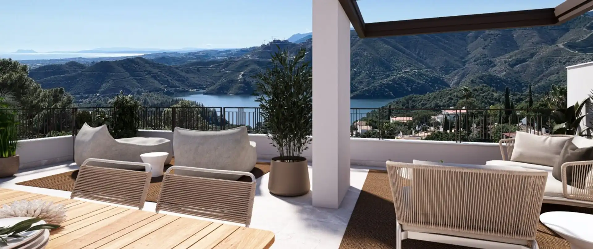 Modern terrace with mountain and lake views at Almazara Gardens Istán outdoor living area