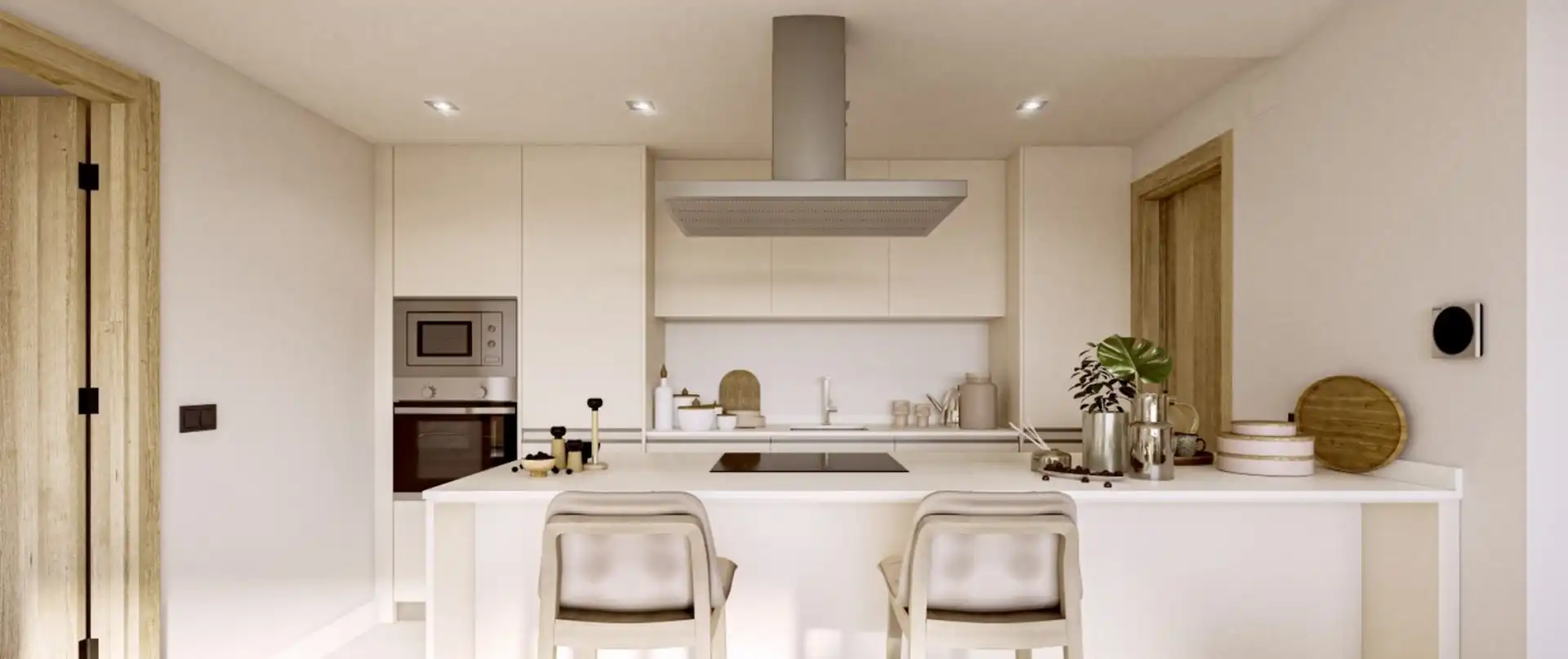 Modern white designer kitchen with island and integrated appliances at Almazara Gardens Istán luxury development