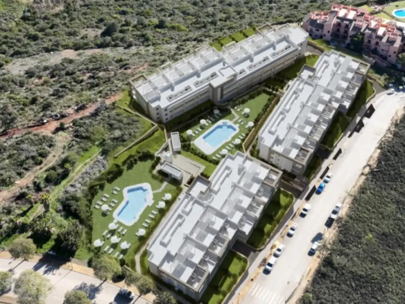 Aerial view of contemporary white apartment buildings with swimming pools, terraces, and landscaped grounds