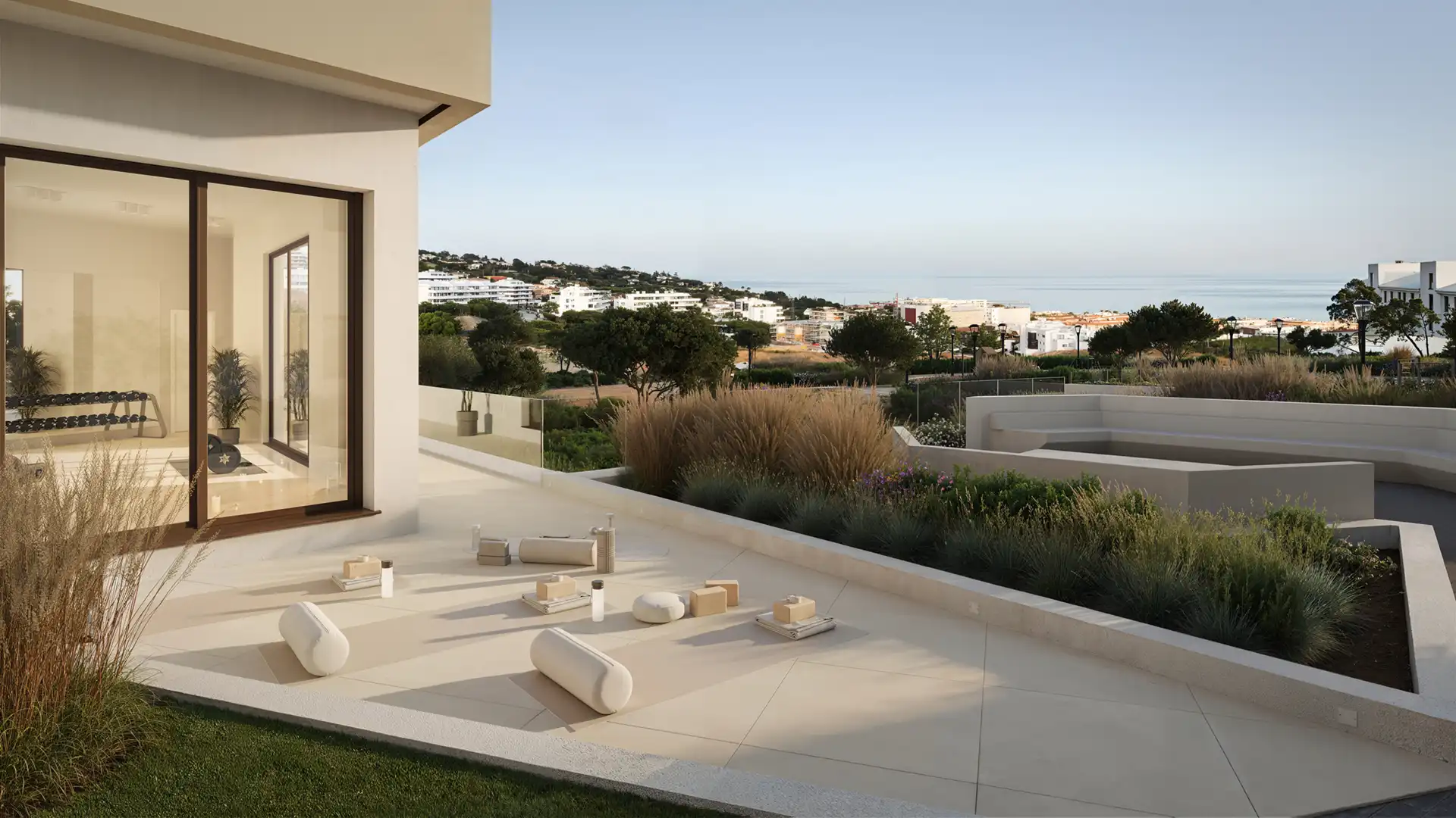 Luxury modern villa terrace with minimalist seating area, landscaped gardens, and panoramic ocean coastal views