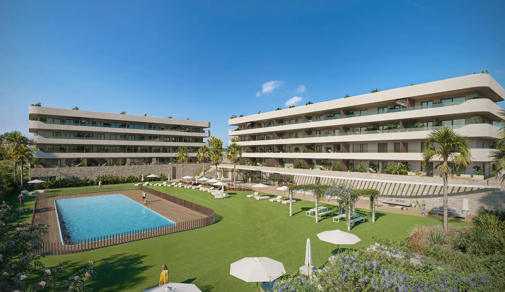 Luxury residential complex at Ocean Garden Residences featuring outdoor pool, sun loungers, palm trees, and manicured lawns between two modern apartment buildings