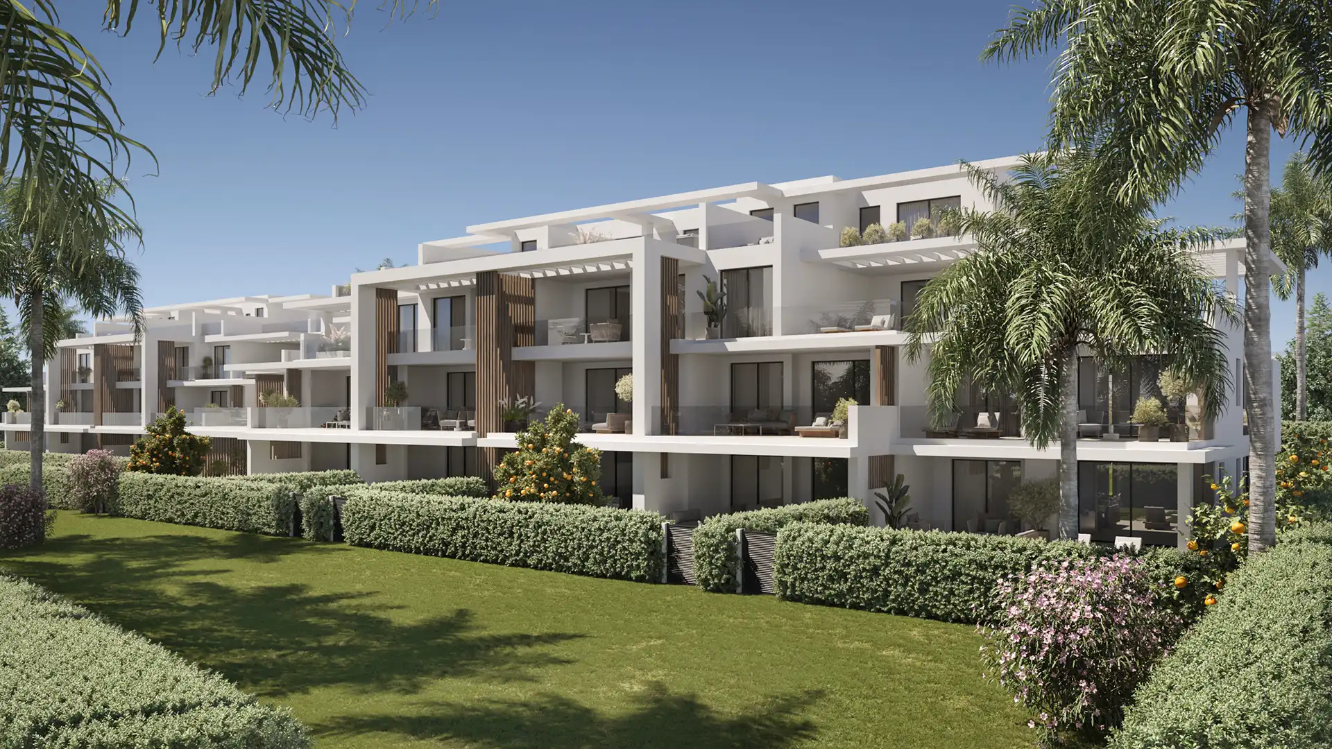 Royal Park Estepona contemporary white apartment complex with wood-clad balconies, lush gardens, and palm trees under blue sky