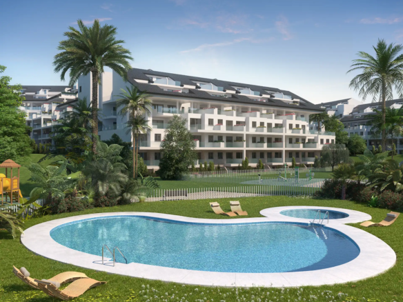 Modern white apartment complex with kidney-shaped swimming pool, palm trees, sun loungers, and children's playground in lush green grounds