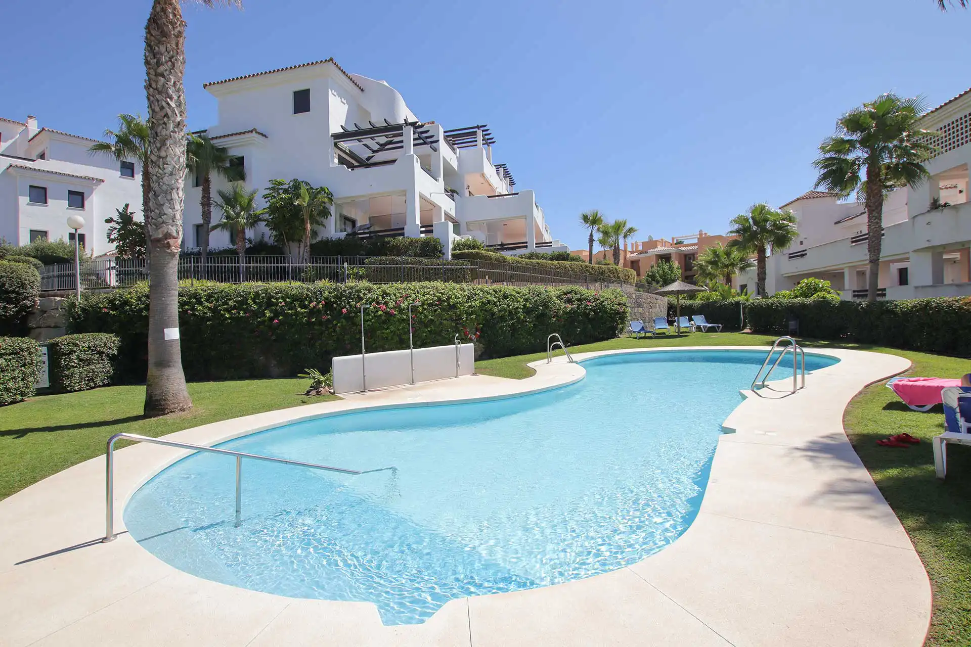 Communal swimming pool and landscaped gardens at Lotus Doña Julia, Casares